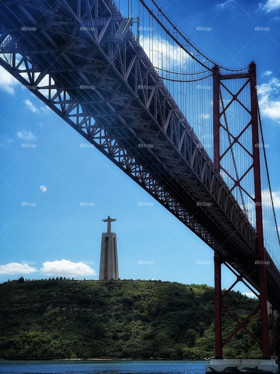 Lisbon harbor with Christ the King and 25 de Abril Bridge landmarks 