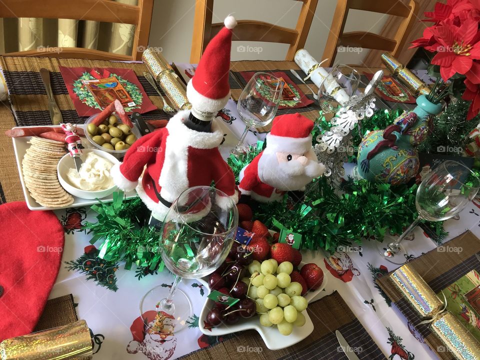 Decorating Christmas table for lunch with entree food cheese wafer cracker olive... at Cheltenham Melbourne Australia 