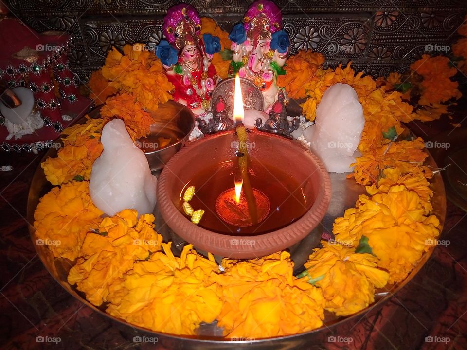 Luxmi-Ganesh worship on Diwali Festival. Lakshmi is the goddess of wealth and prosperity and also personifies beauty, grace, and charm. Ganesh is the lord of wisdom and remover of obstacles.