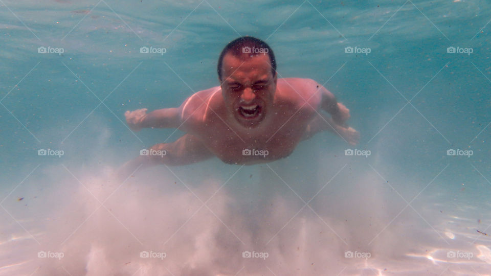 Man swimming under water in sea