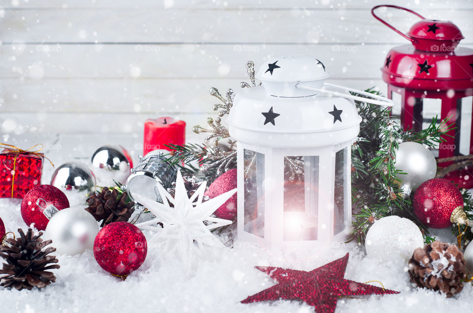 christmas latern with cristmas decoration on a snow