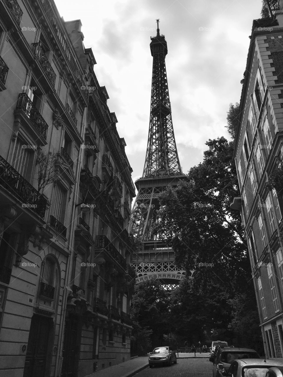 Beautiful Eiffel Tower seen from a small Parisian street 