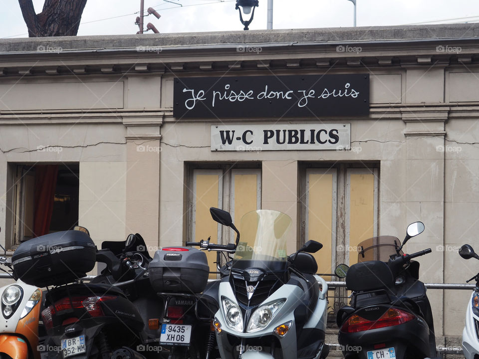 Public toilets with artwork slogan by Ben translates as "I pee therefore I am", Nice, France.