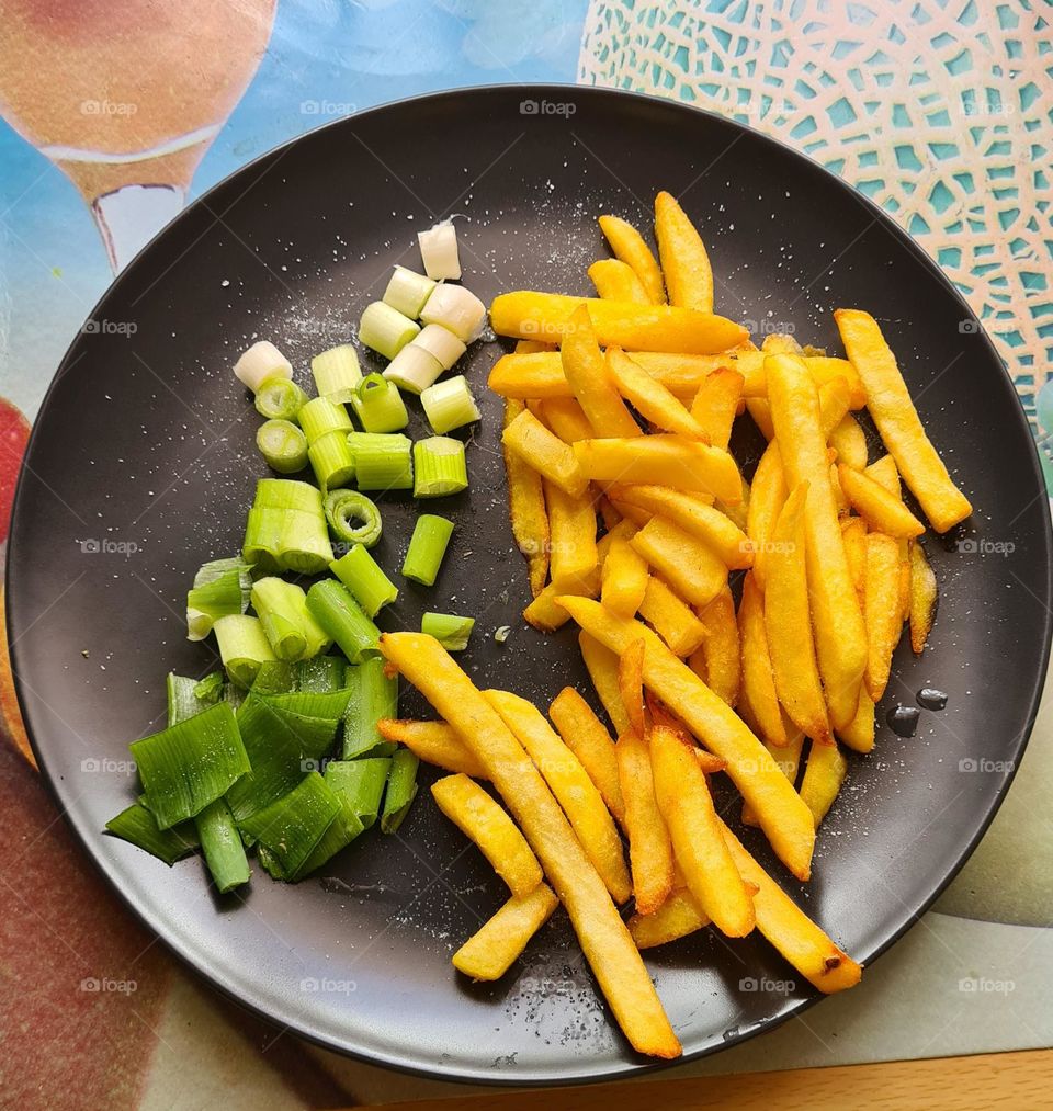 Fries and green onions on a plate food