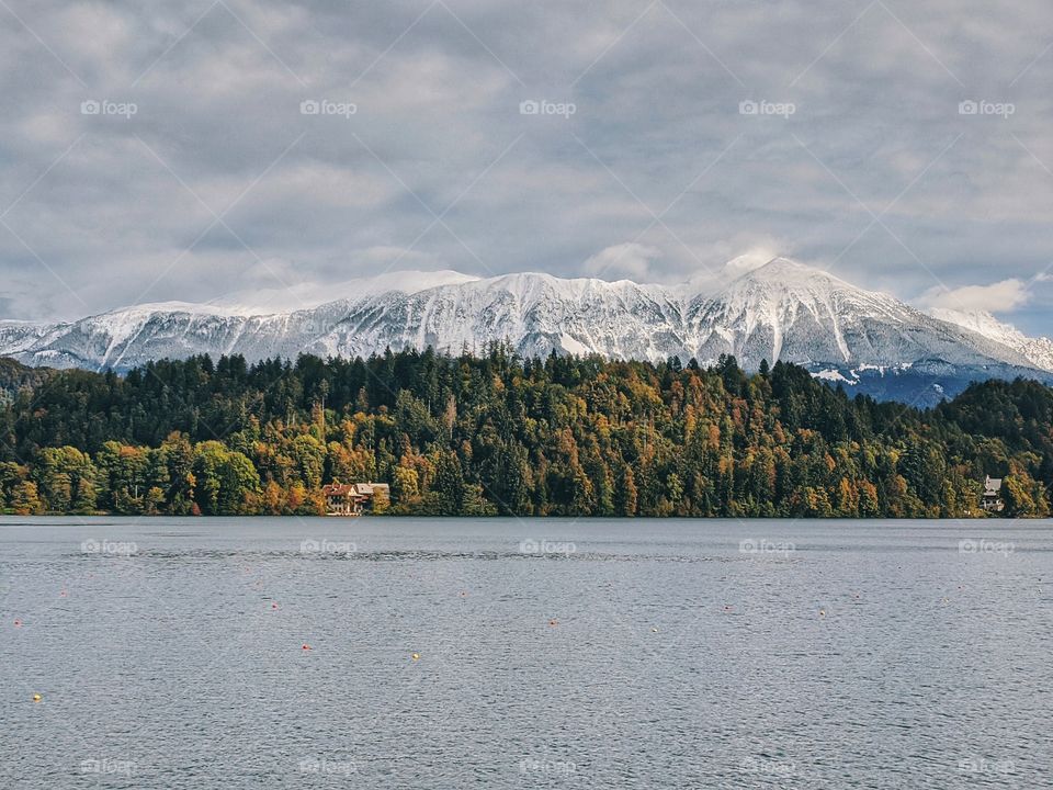 View of the snow-capped mountain peaks against the backdrop of Lake Bled.