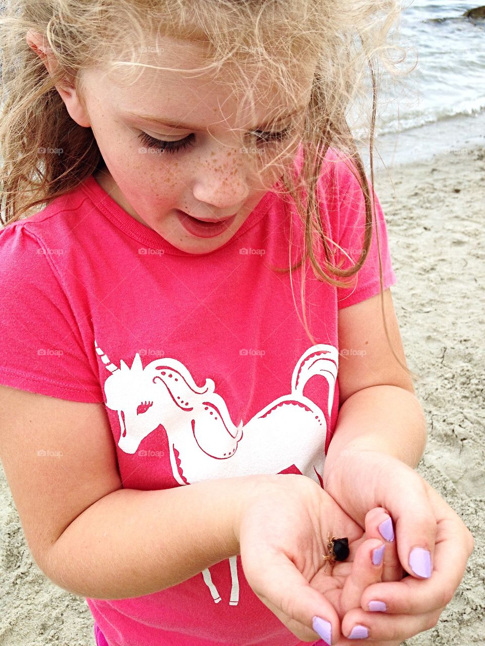 Look what I caught!  Exploring the water, she caught a hermit crab. 
