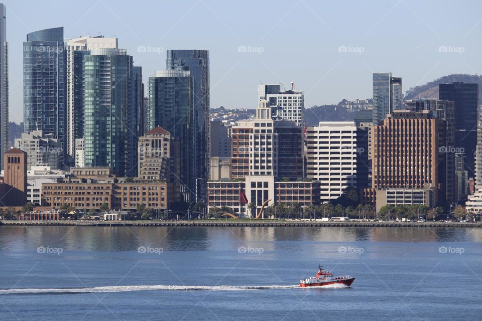 enjoying the view of the city across the water