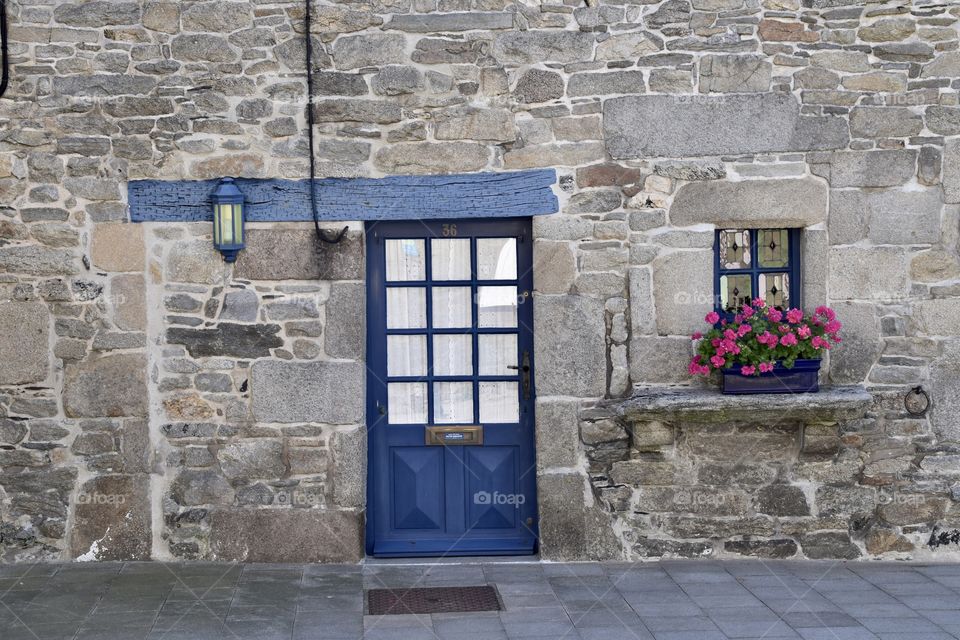Old vintage door in a historic house with stones in Bretagne / brittany 