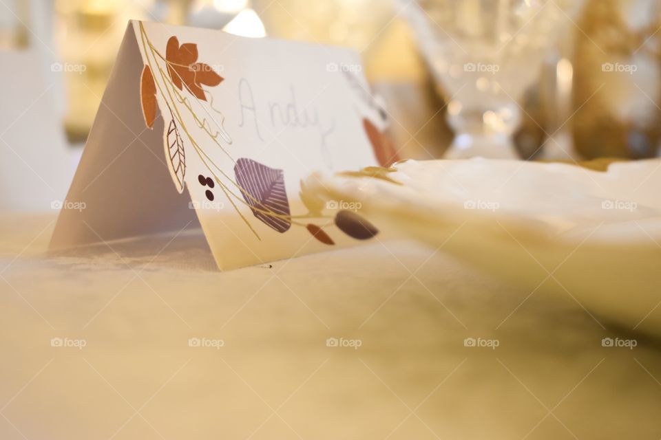 Place card on dinner table set for Thanksgiving holiday feast 