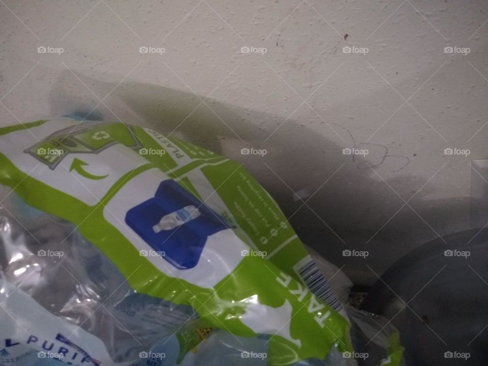 Green and white plastic water 💦 bottle container.