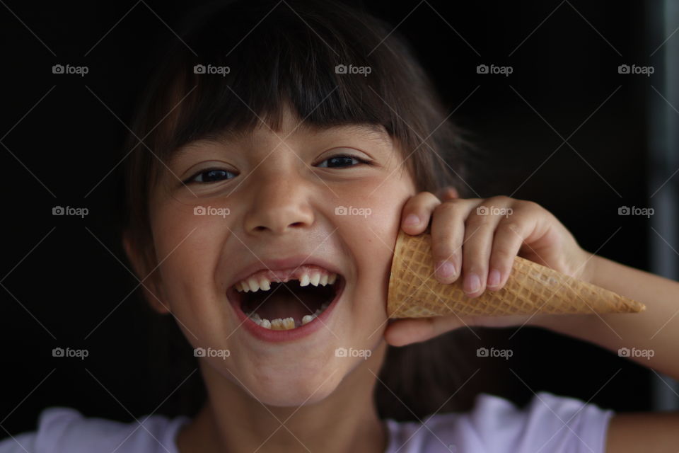 Cute little girl plays with waffle ice cream cone