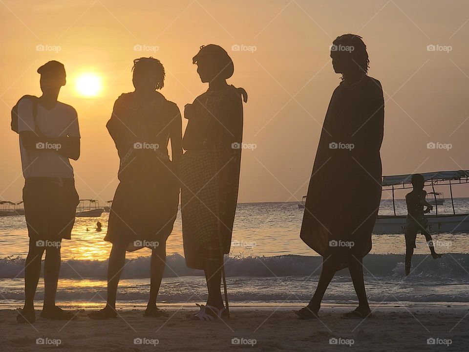 Silhouettes of people on the beach in Zanzibar