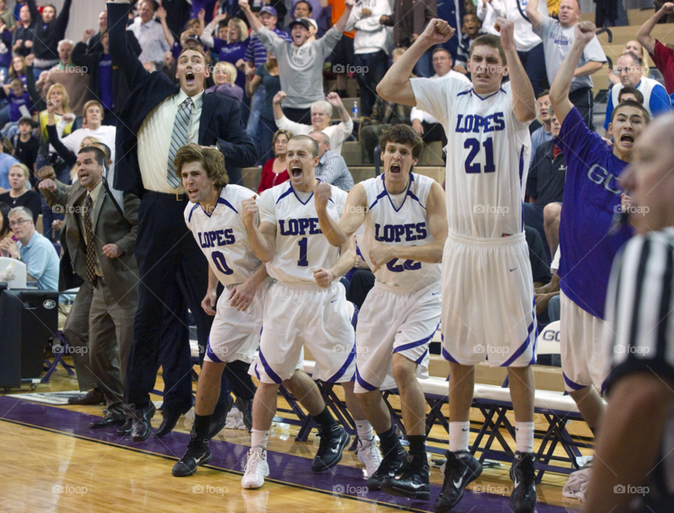celebration. basketball team members celebrate after a last second shot scores. by arizphotog