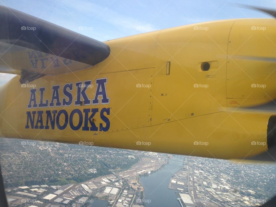 Alaska Airlines Propeller yellow plane airborne. Alaska airlines yellow prop plane airborn