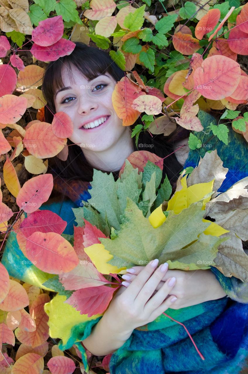 Smiling Young Girl on Autumn Background