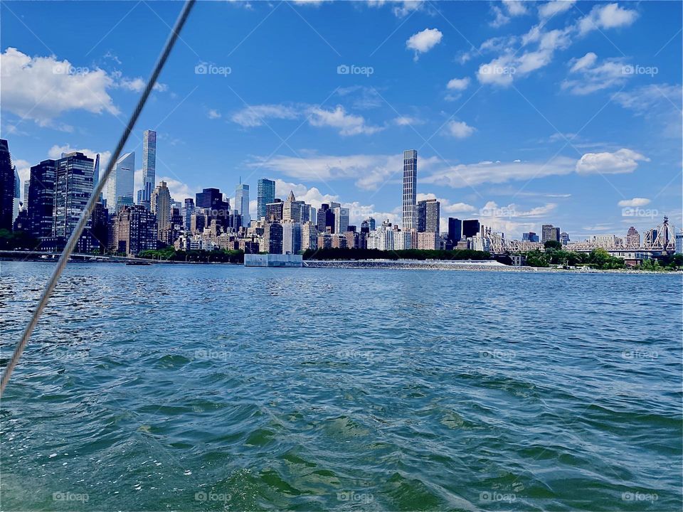 The glorious „Manhattan“ skyline is best seen from the waters of the „East River“ in the vicinity of „Newtown Creek“ where we went with our beautiful new boat for our first sailing lesson. 2023. Hypnotic Productions