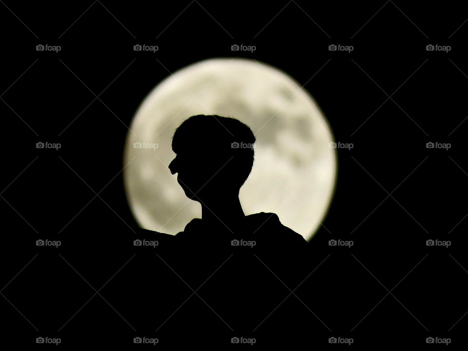 My brother with the moon behind him