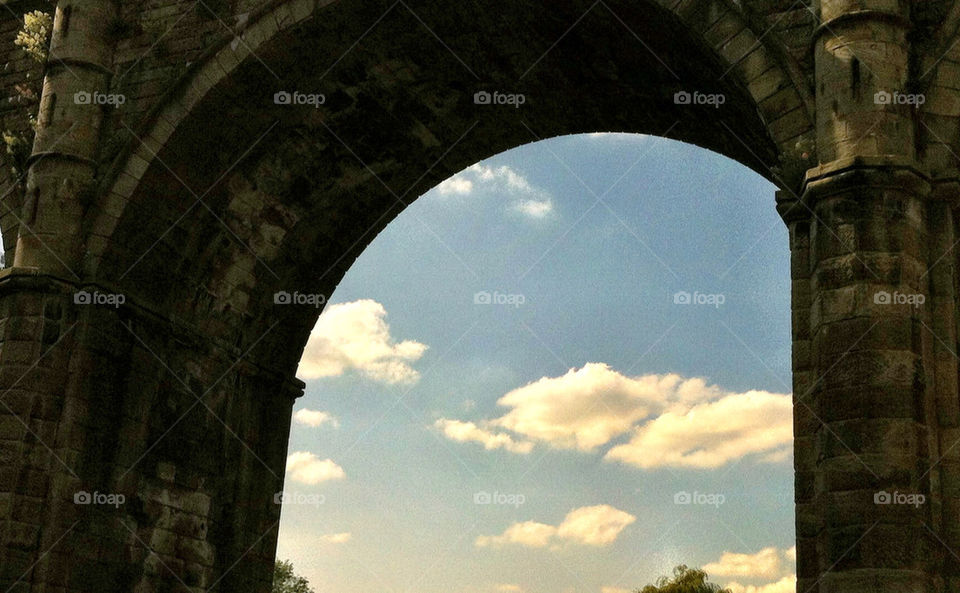 Blue sky and clouds framed by knaresborough bridge