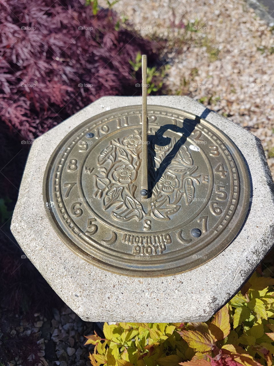 A brass sundial in a garden