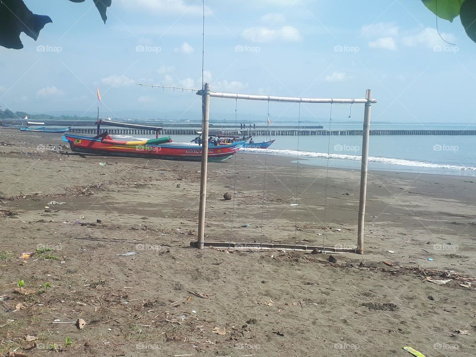 goal made of wood on the beach