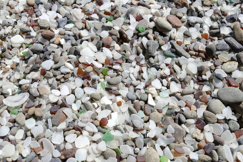 The Glass Beach located on the coast of California. The sea glass is a result of a nearby dump that put the trash into the sea. Years after the dump was closed down, an abundance of sea glass began to turn up on the beach nearby. The dry beach is hardly recognizable as glass until you see it close up.