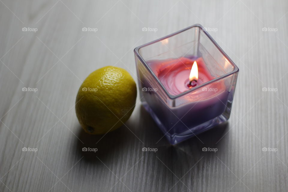 A candle with a lemon