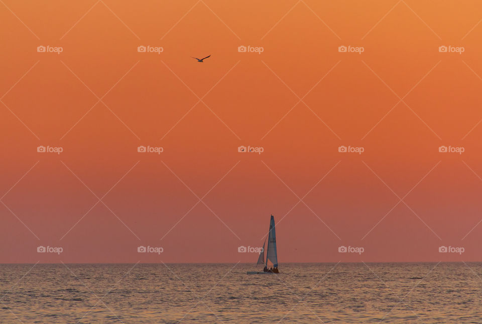 Sailing into the sea at sunset