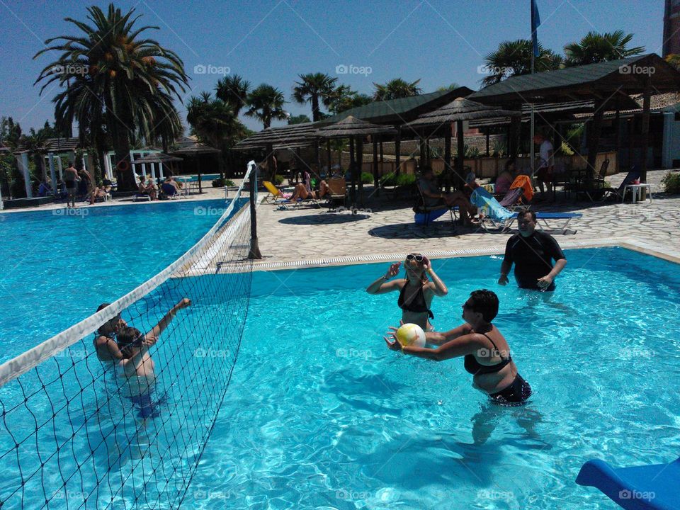 Early summer swimming  - playing with a ball in the swimming pool