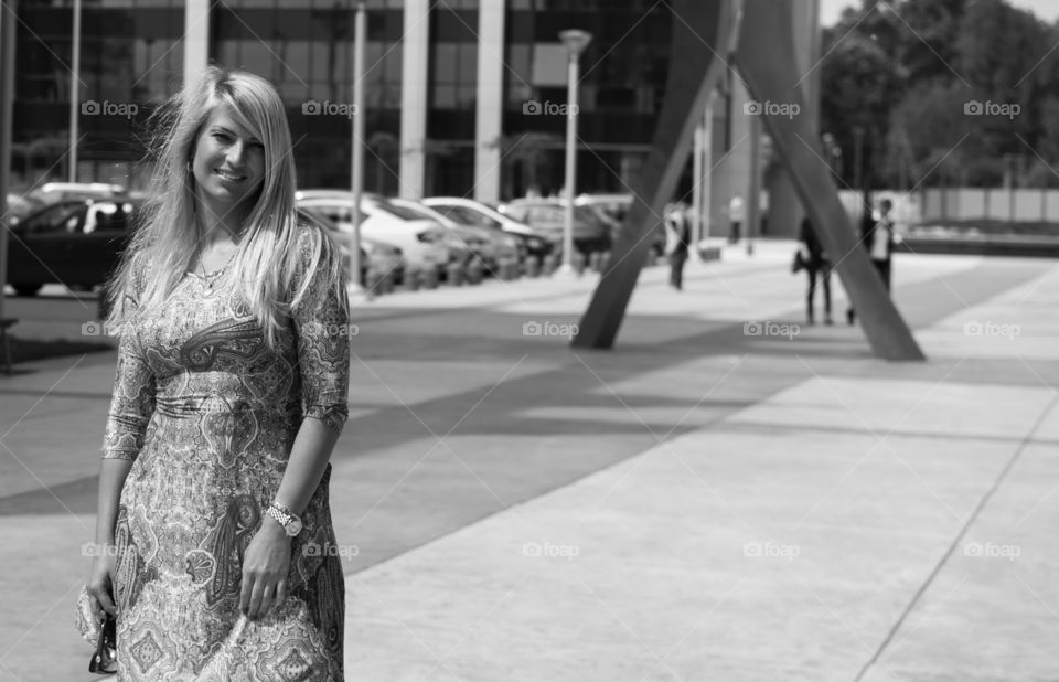 Blonde woman standing on street