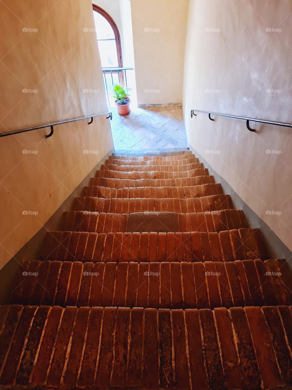 shot from the top of a rustic staircase of an ancient Tuscan palace