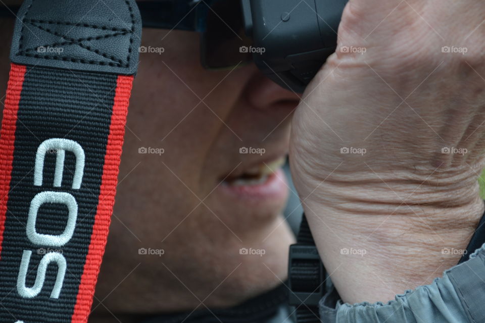 Closeup professional photographer taking photo with camera