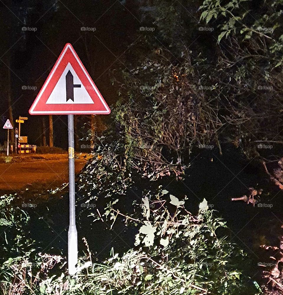 Priority sign Photographed on the right in the evening. Triangle with red border twice.