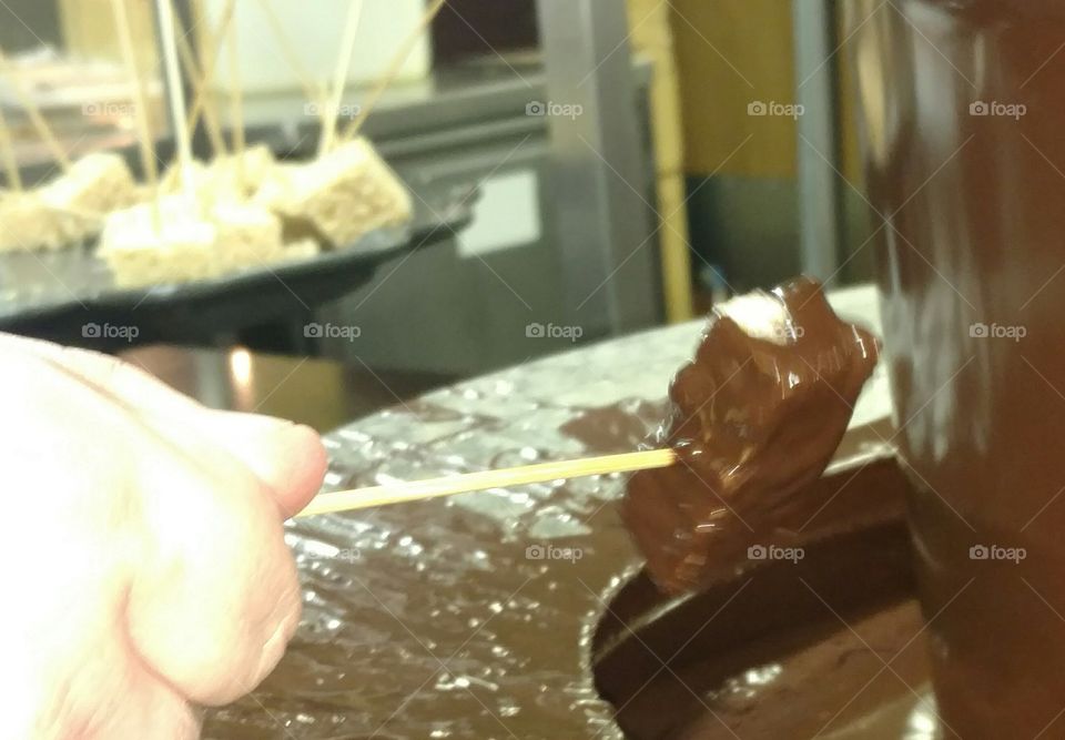 dipping rice crispy treats in a chocolate fountain at Golden Corral