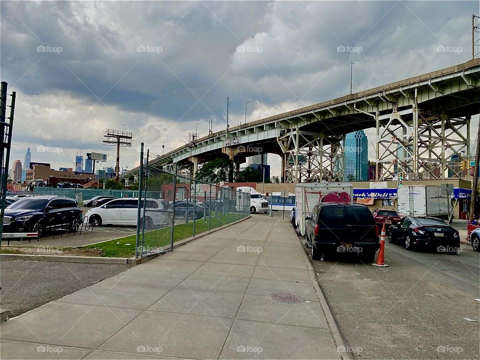 This is the curvatious “Brooklyn Queens Expressway” or “BQE” overpass sloping downwards towards “Newtown Creek” and the “Pulaski Bridge”. 2023. Hypnotic Productions