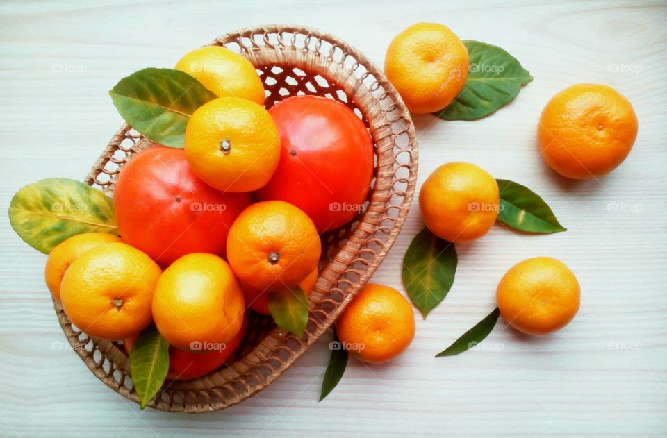 Oranges and pomegranate in basket