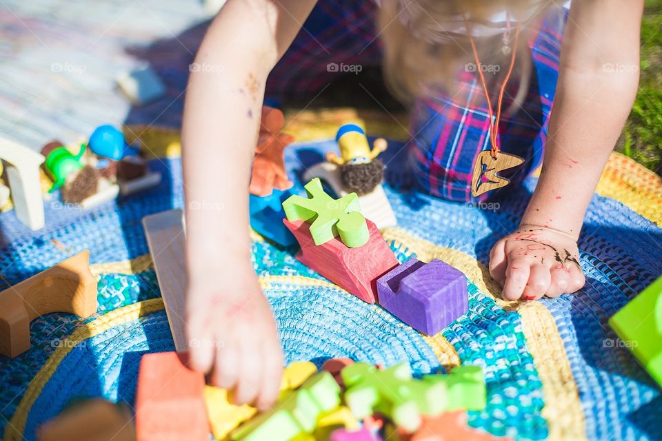 Kids playing with a wooden toys