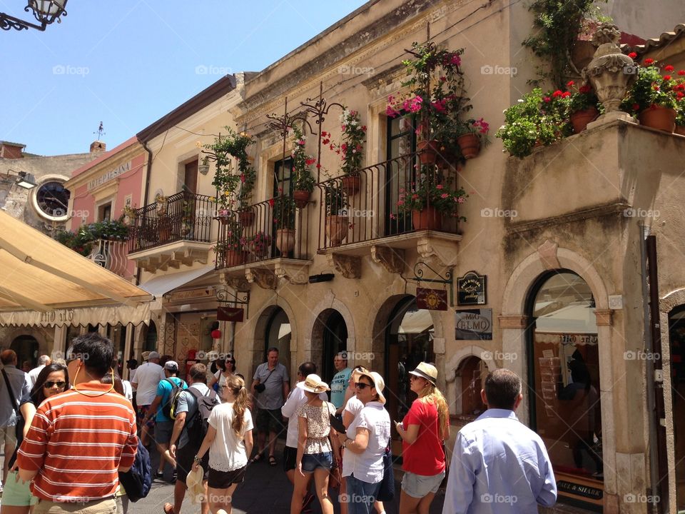 People in holiday. People is walking in the village between the houses in Taormina,Italy