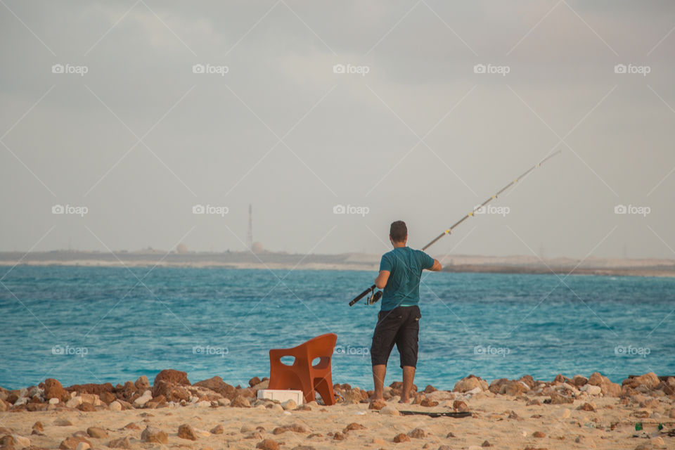 A man from fishing by the beach