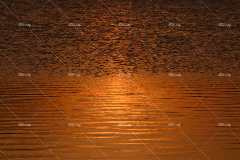 Natural pattern sunset light on water