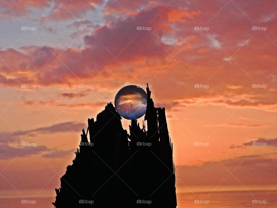 Crystal ball sunset over the tree silhouette 