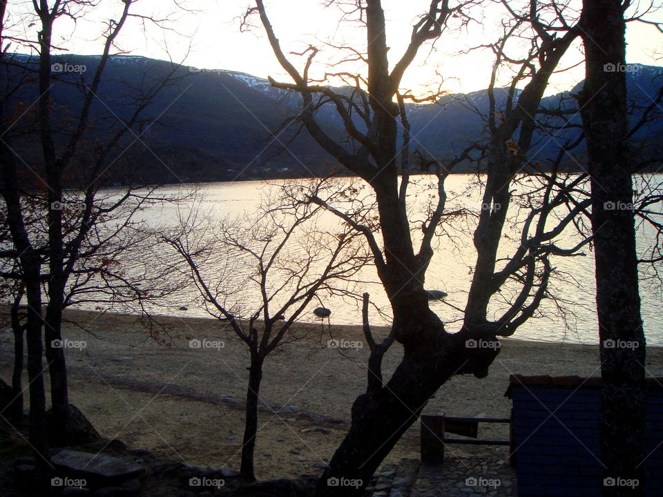 the sunset in the mountain, the river and the trees