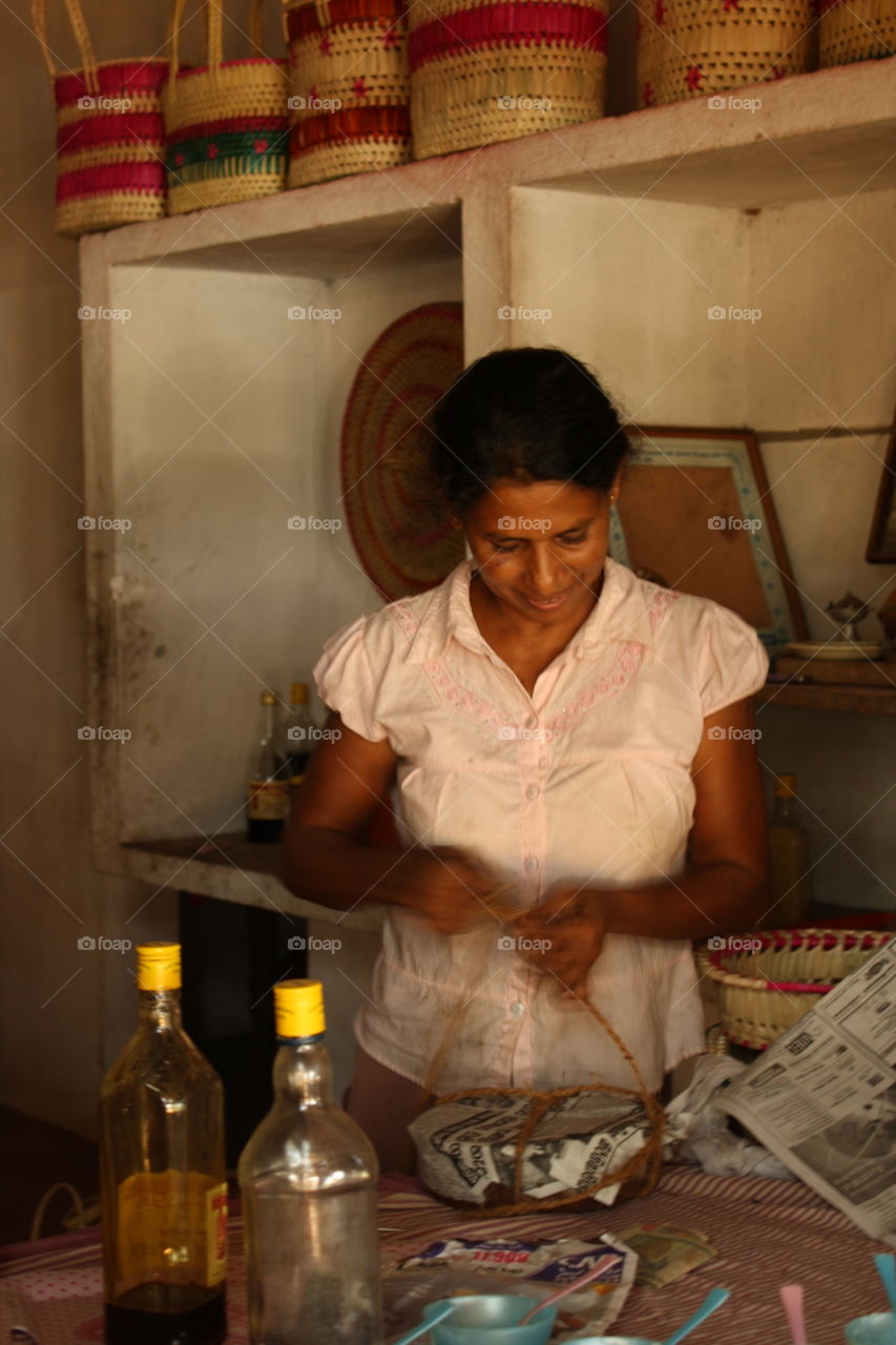 Sri Lanka Shop Woman Packaging a Purchase. Taken July 2010.