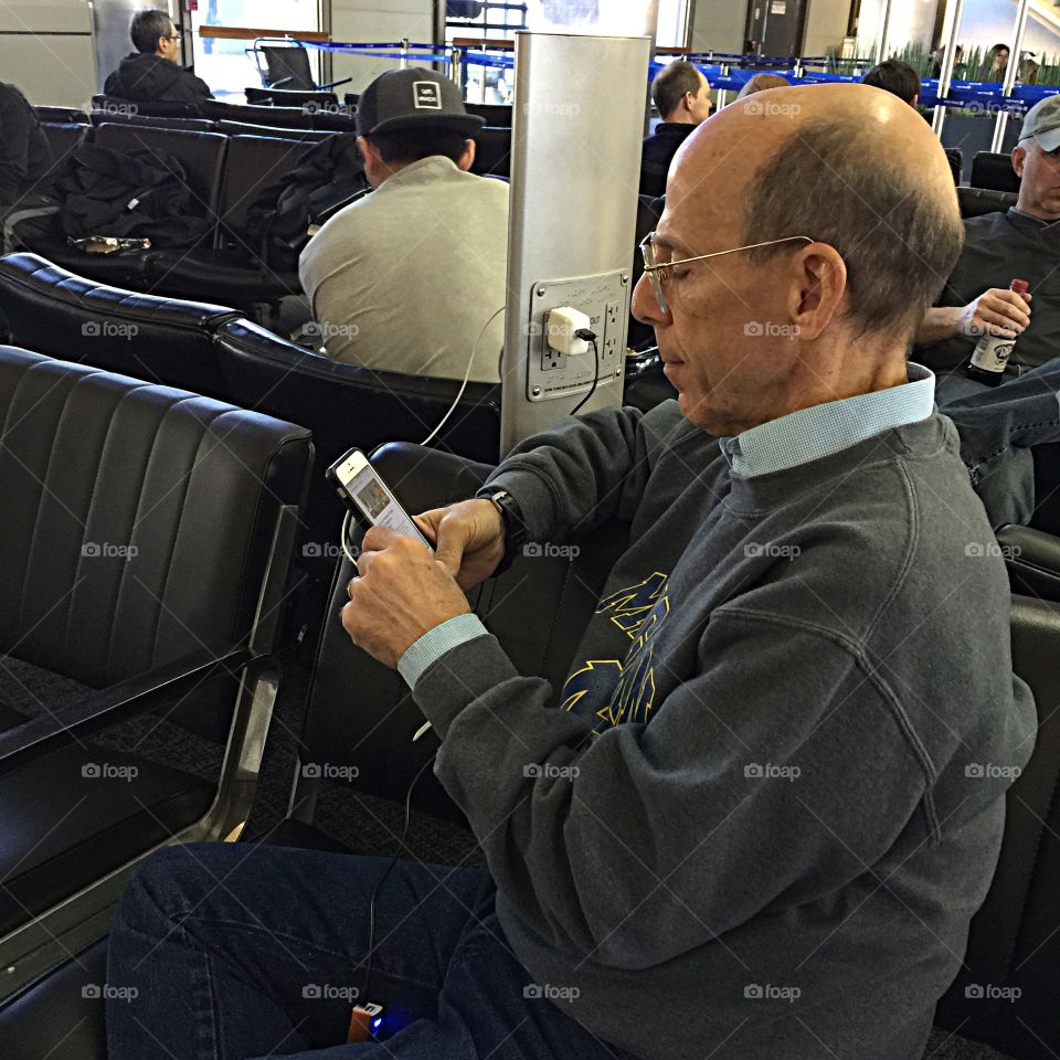 A man using technology at the airport