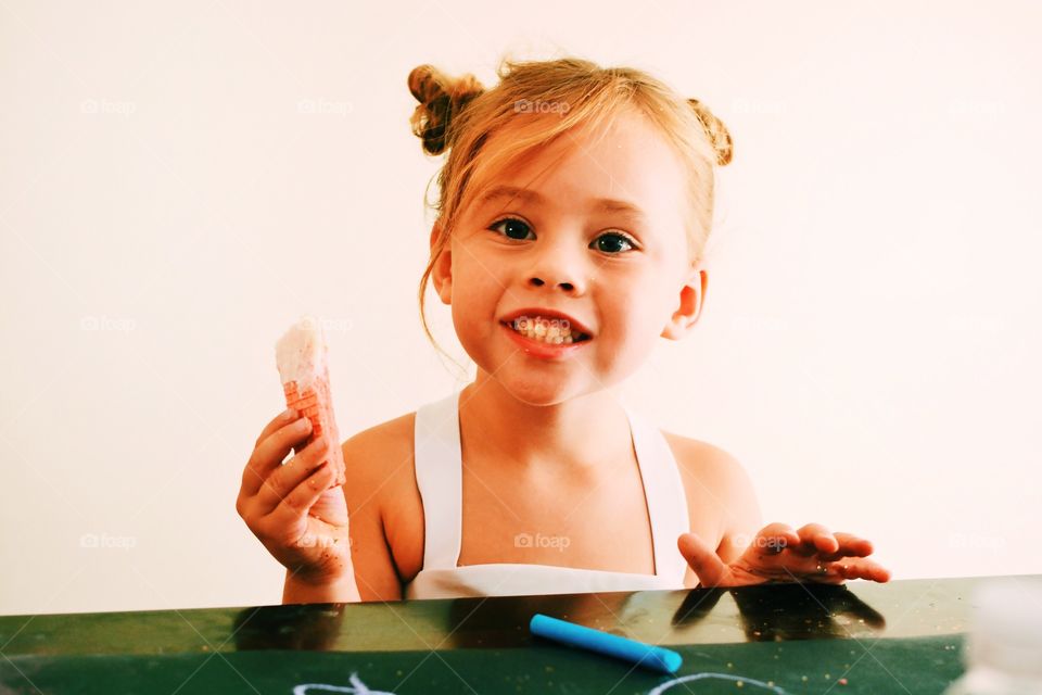 Cute girl eating cream waffle bar