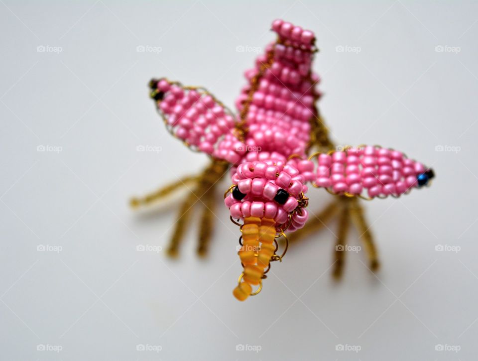 bird from beads on a white background art