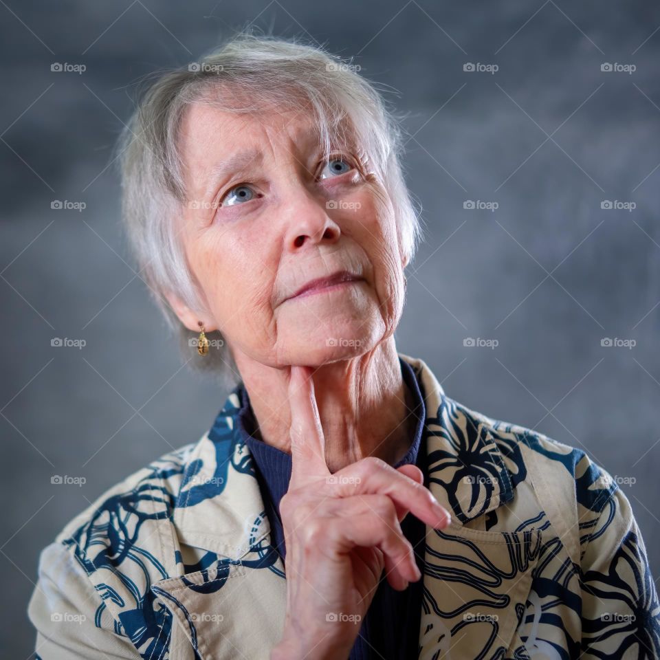 An elderly lady ponders a thought. 