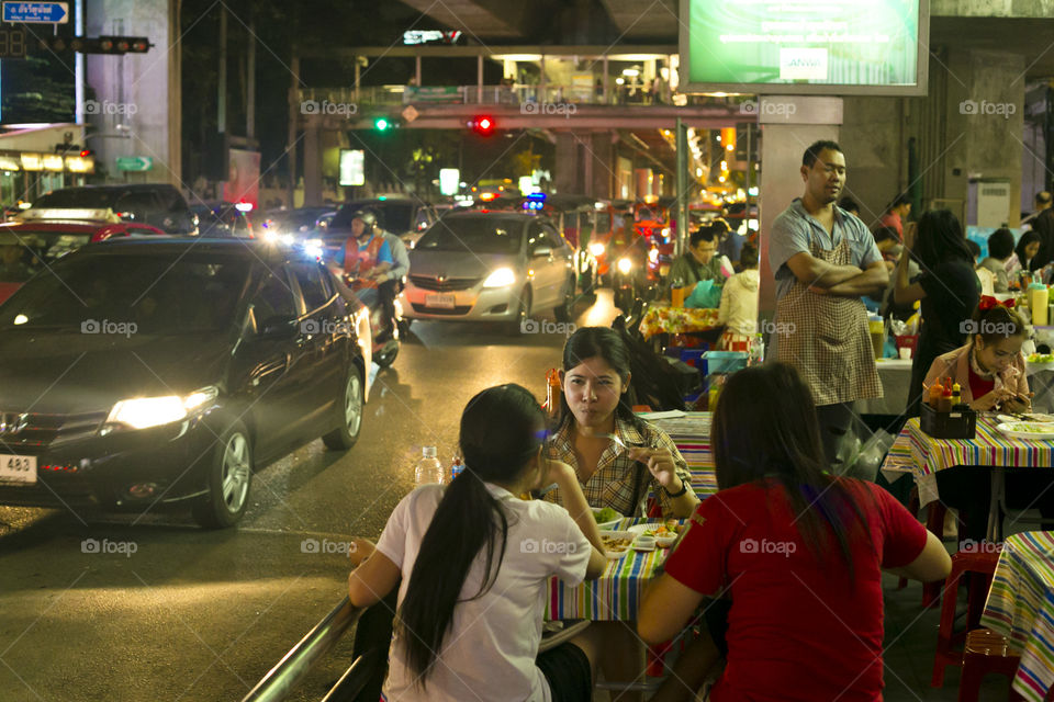 Dinner on the streets of Bangkok. Typical daily night light scenery of Bangkokians