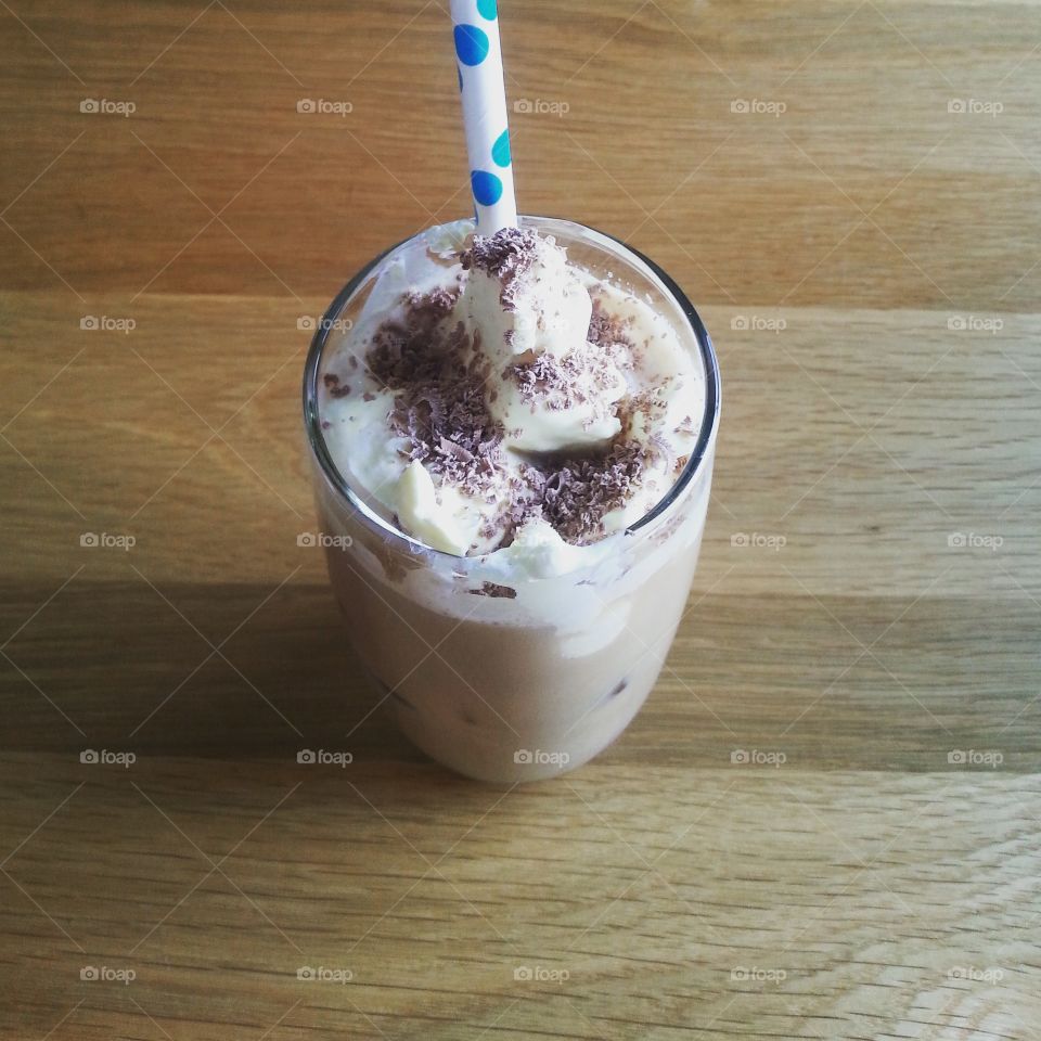 iced mocha served with cream and polka dot straw