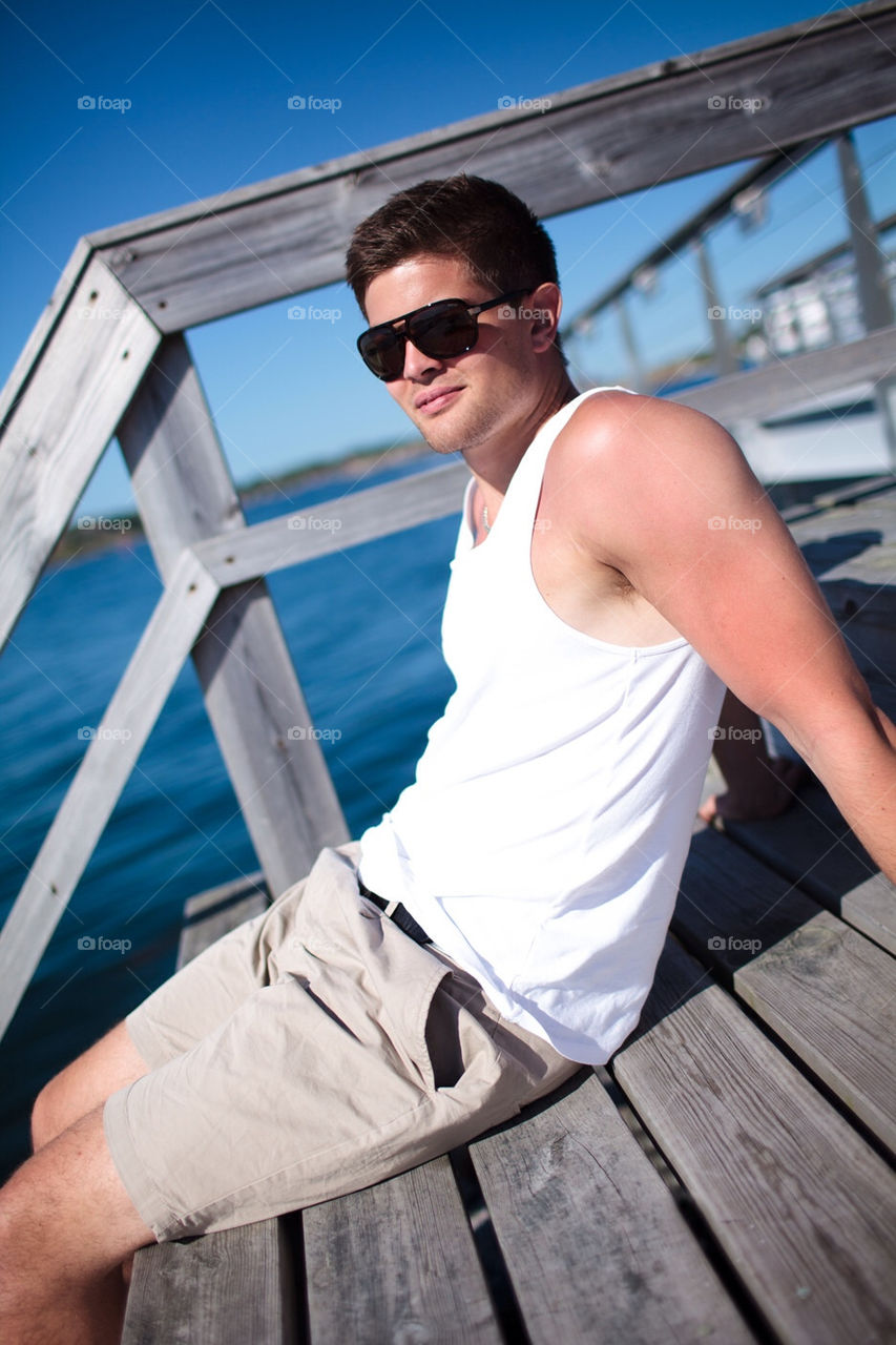 Young man in tanktop and sunglasses