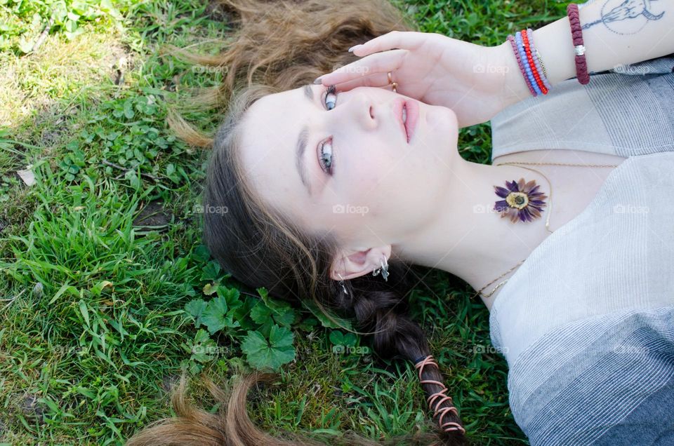 Portrait of Young Girl on Background of Daisies